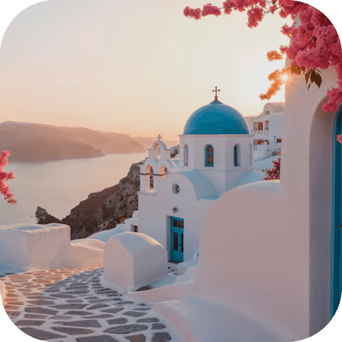 Greek island sunset over a whitewashed village with a blue-domed church
